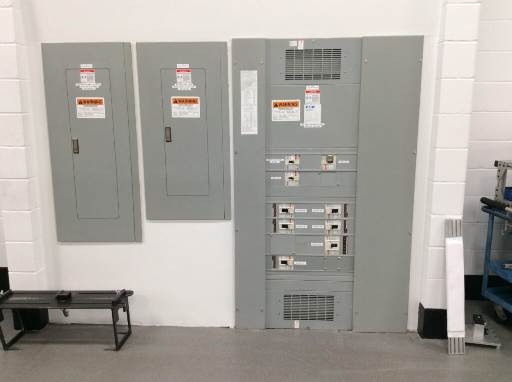 Three large commercial electric panels on wall